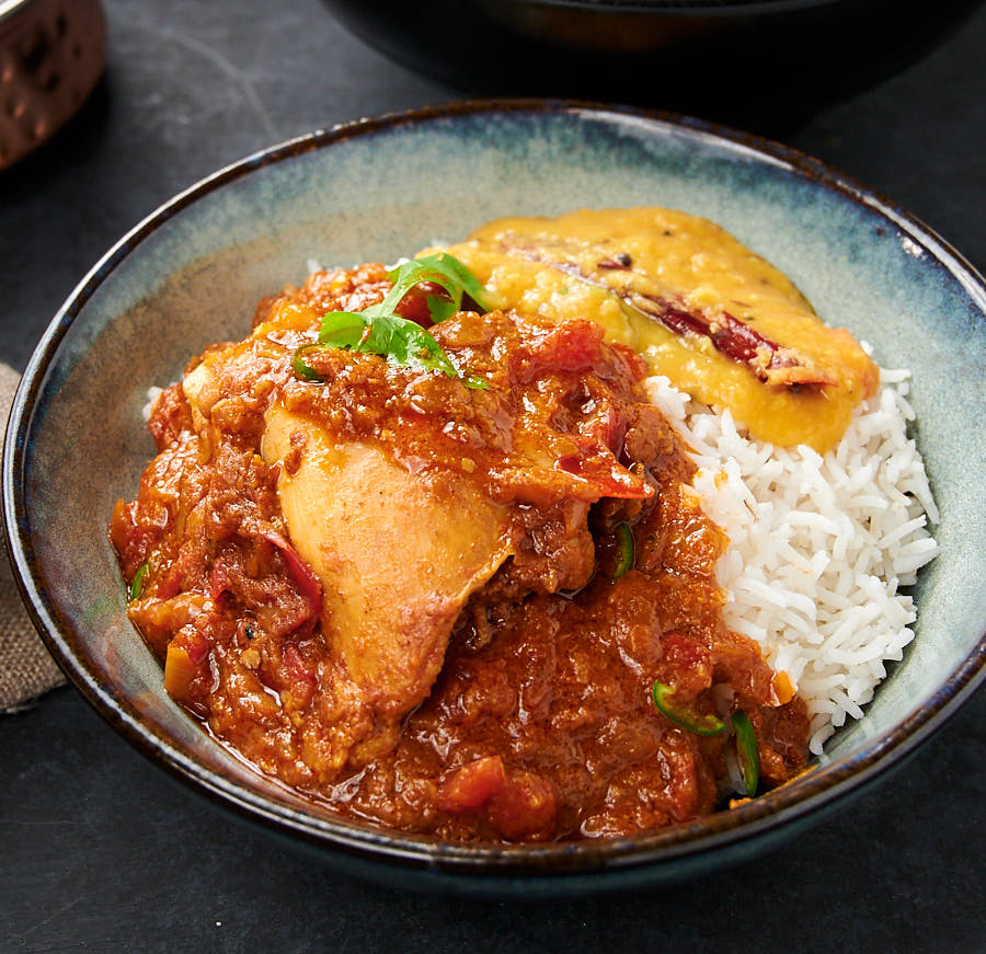 Dinner! Simple chicken curry, dal and rice in a ceramic dinner bowl.