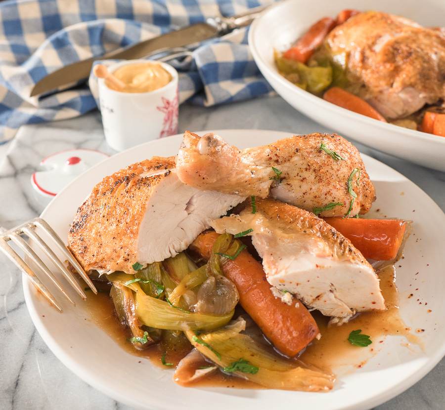 French chicken in a pot cut up on a plate.