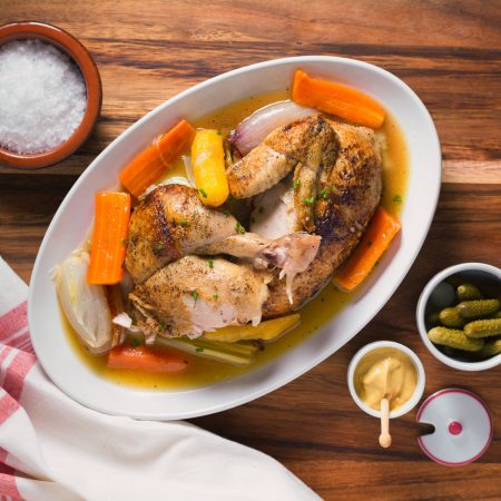 French chicken in a pot top view on oval plate