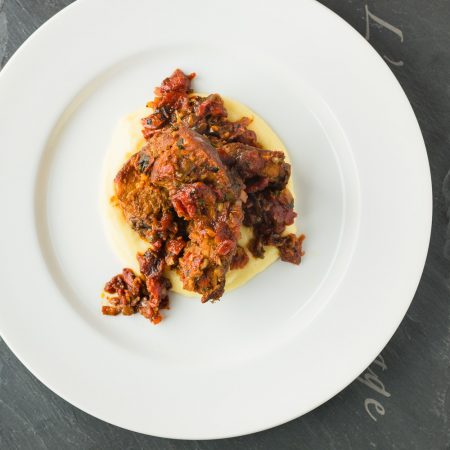 Melting pork back ribs, fire roasted tomatoes and cheese polenta come together in this fine dining riff on Mexican pork chili.