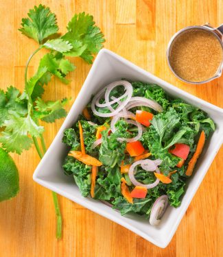 Lime, soy and tahini dress this healthy kale salad.