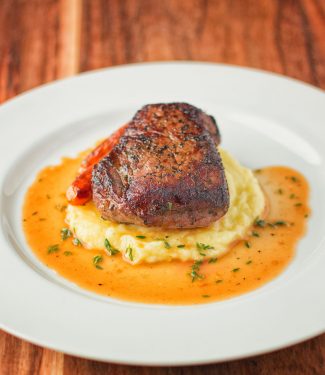 Steak with thyme infused white wine sauce