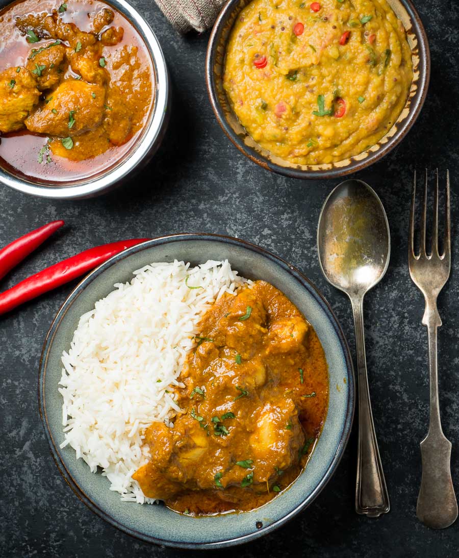 Bowl of chicken madras curry with rice and lentils from above.