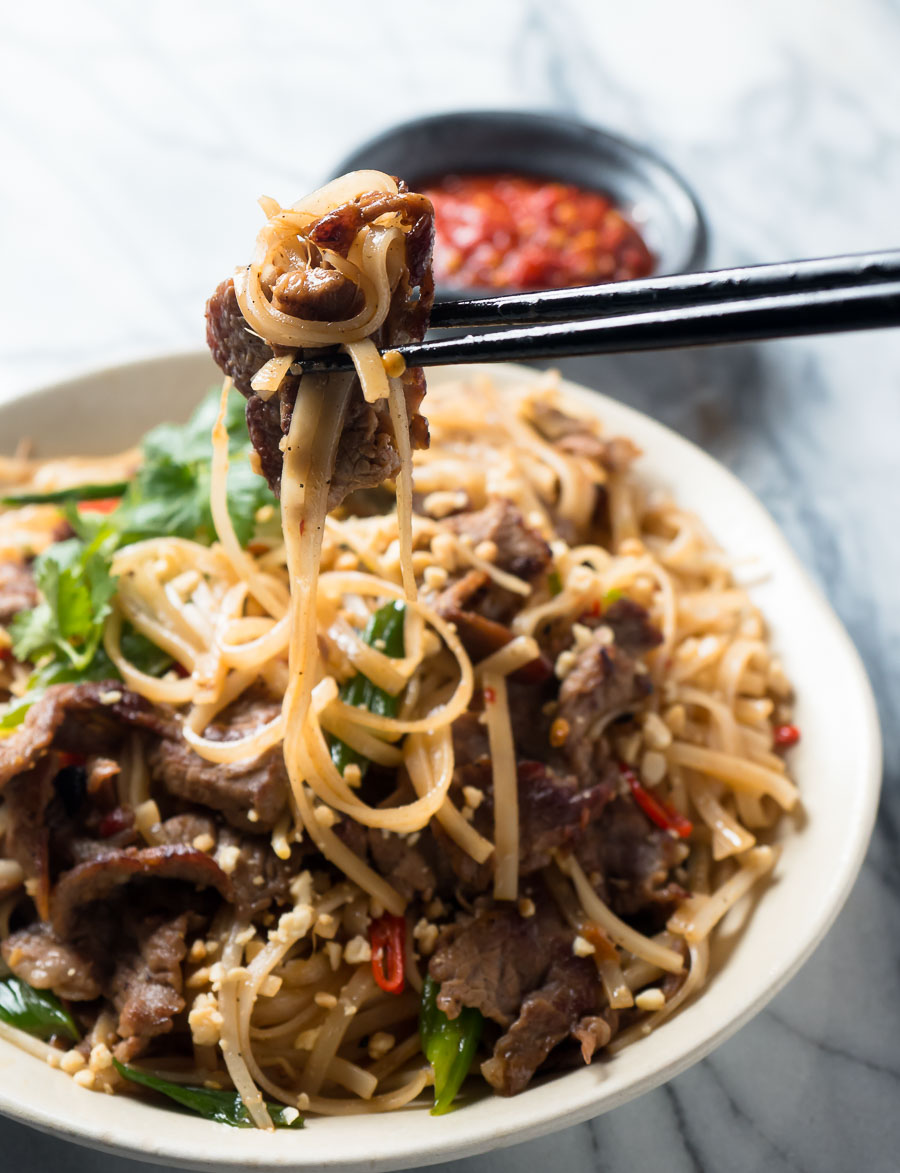 Thai beef noodles - bite held in chopsticks.