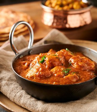 Indian restaurant dhansak curry in a karai bowl from the front.