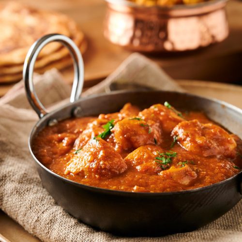 Indian restaurant dhansak curry in a karai bowl from the front.