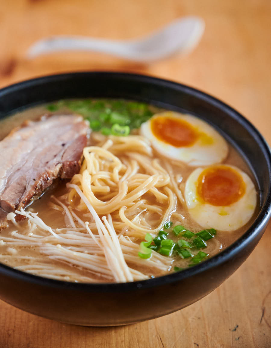 Medium boiled eggs in a bowl of ramen broth