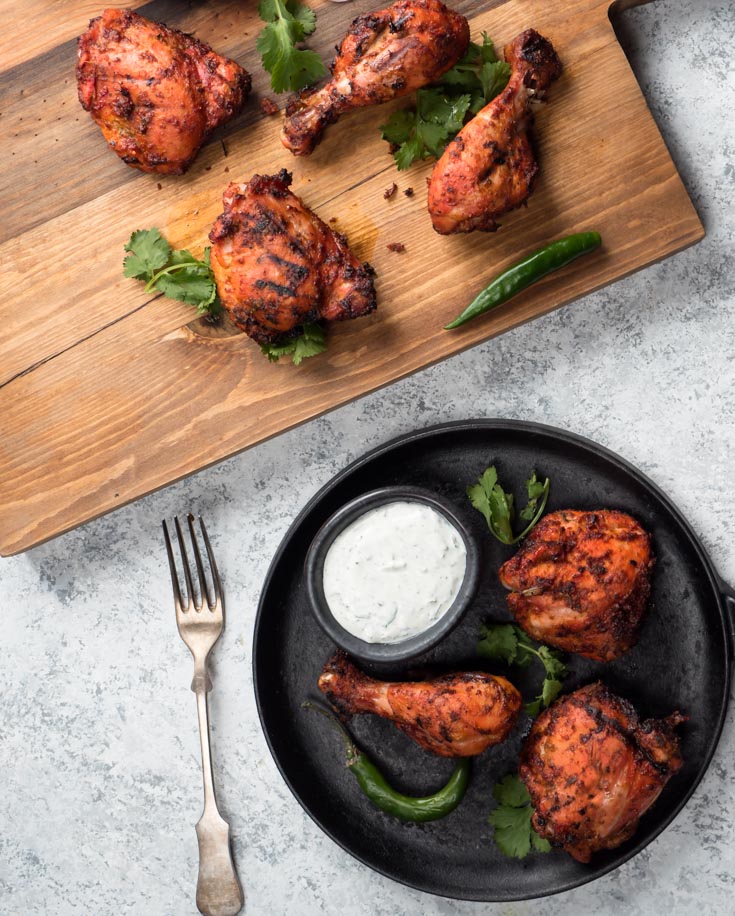 tandoori chicken on cast iron with mint raita