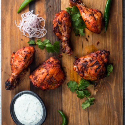 Tandoori chicken on a board from above.