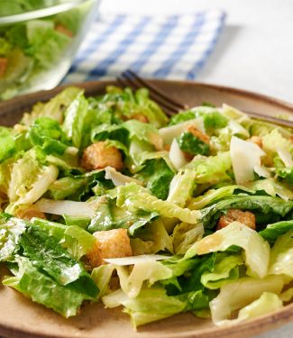 Close up of Caesar salad on a plate from the front.