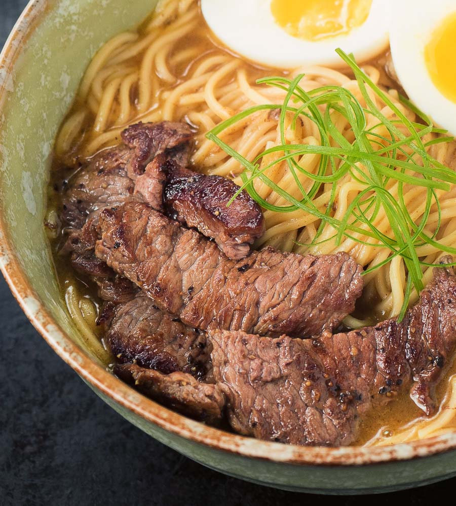 Close up of beef in a bowl of curry ramen.