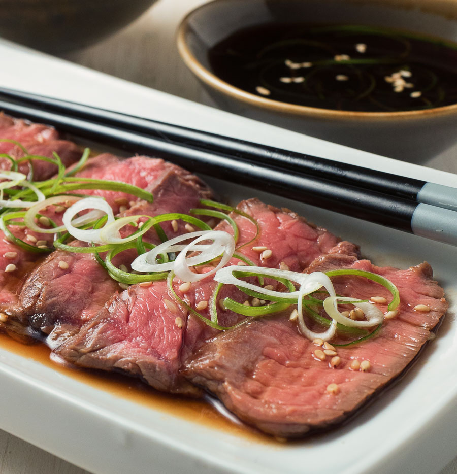 beef tataki on a white plate close-up.