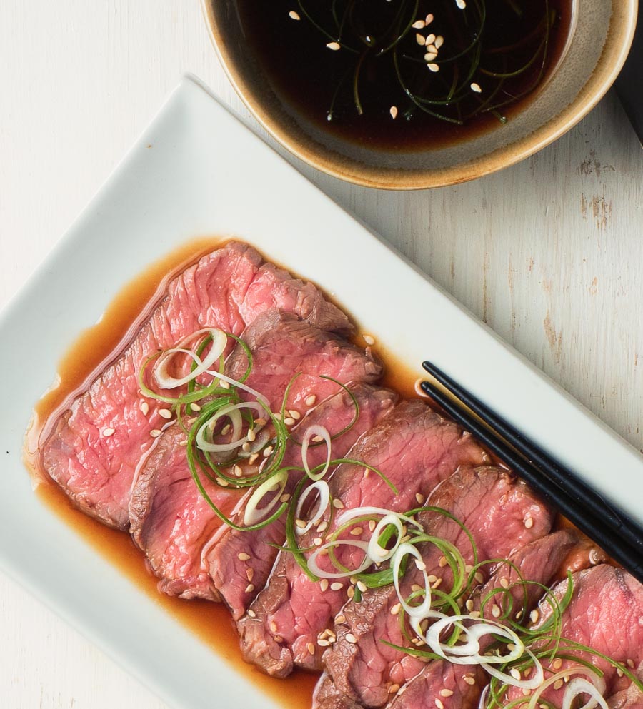 beef tataki in a pool of ponzu sauce.