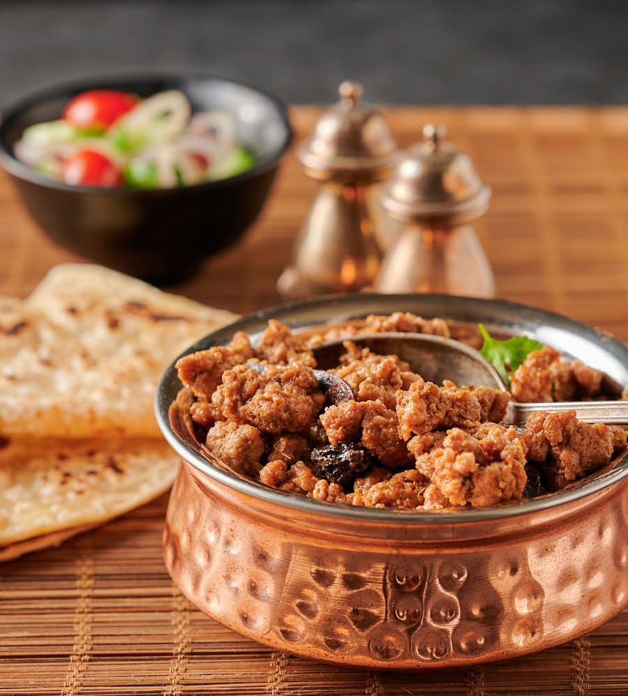 Lamb keema in a copper bowl from the front.