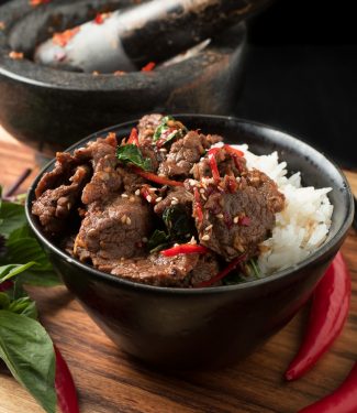 Thai basil beef with red chilies and jasmine rice front view.