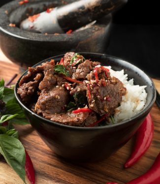 Thai basil beef with red chilies and jasmine rice front view.