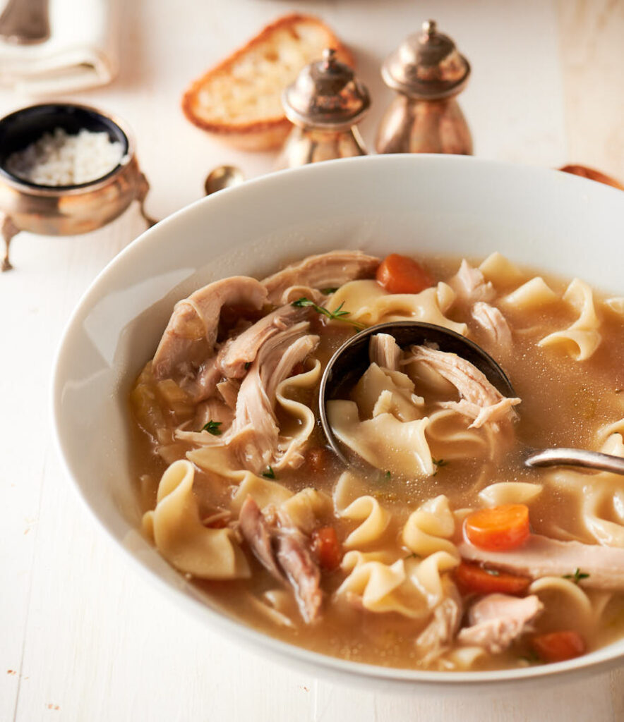 Serving bowl of homemade chicken noodle soup from the front.