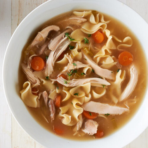 Serving bowl of homemade chicken noodle soup from above.