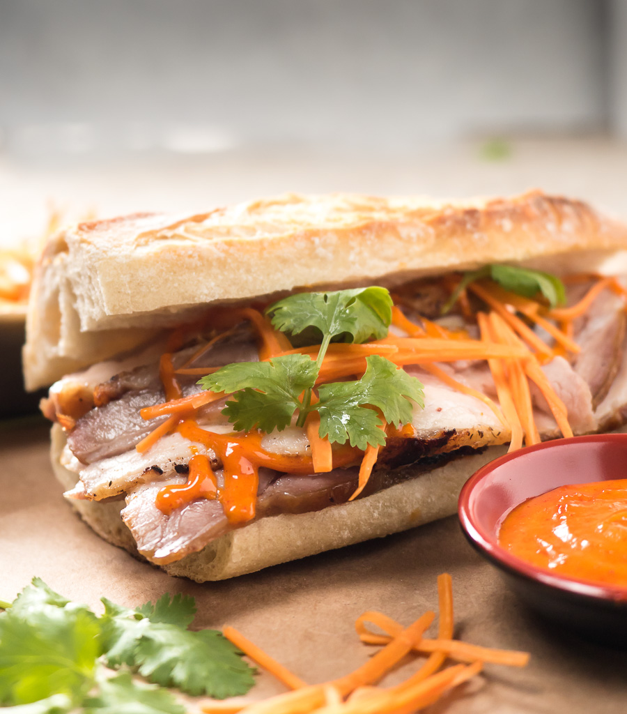 Close-up of pork belly banh mi with Gochujang mayo from the front