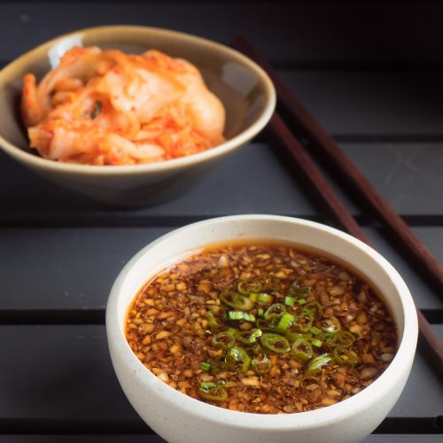 Korean bulgogi sauce in a white bowl on black background.