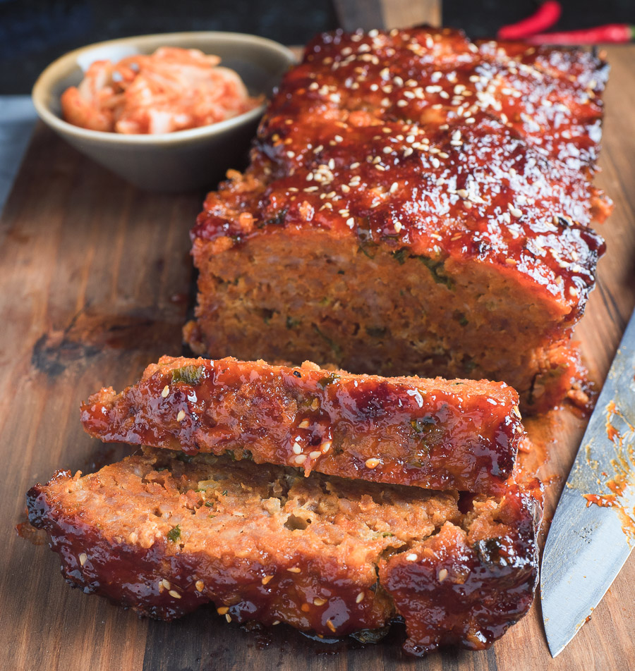 ReKorean meatloaf with gochugang glaze sliced on a cutting board.