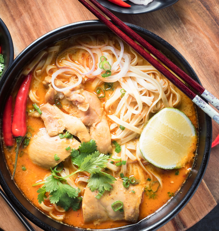 khao soi in a black bowl from above