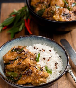 Nadan chicken curry in a bowl with rice.