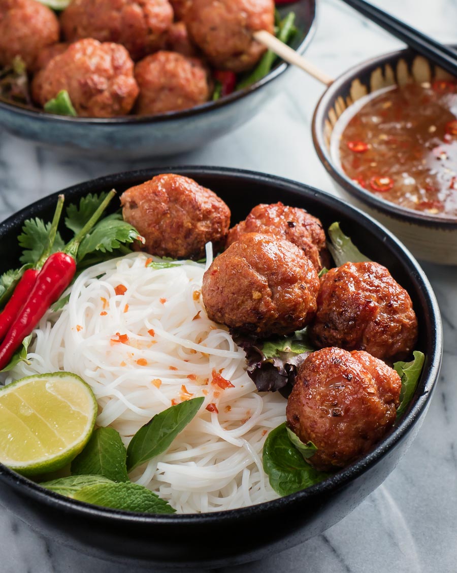 Bun cha in a black bowl from the front.