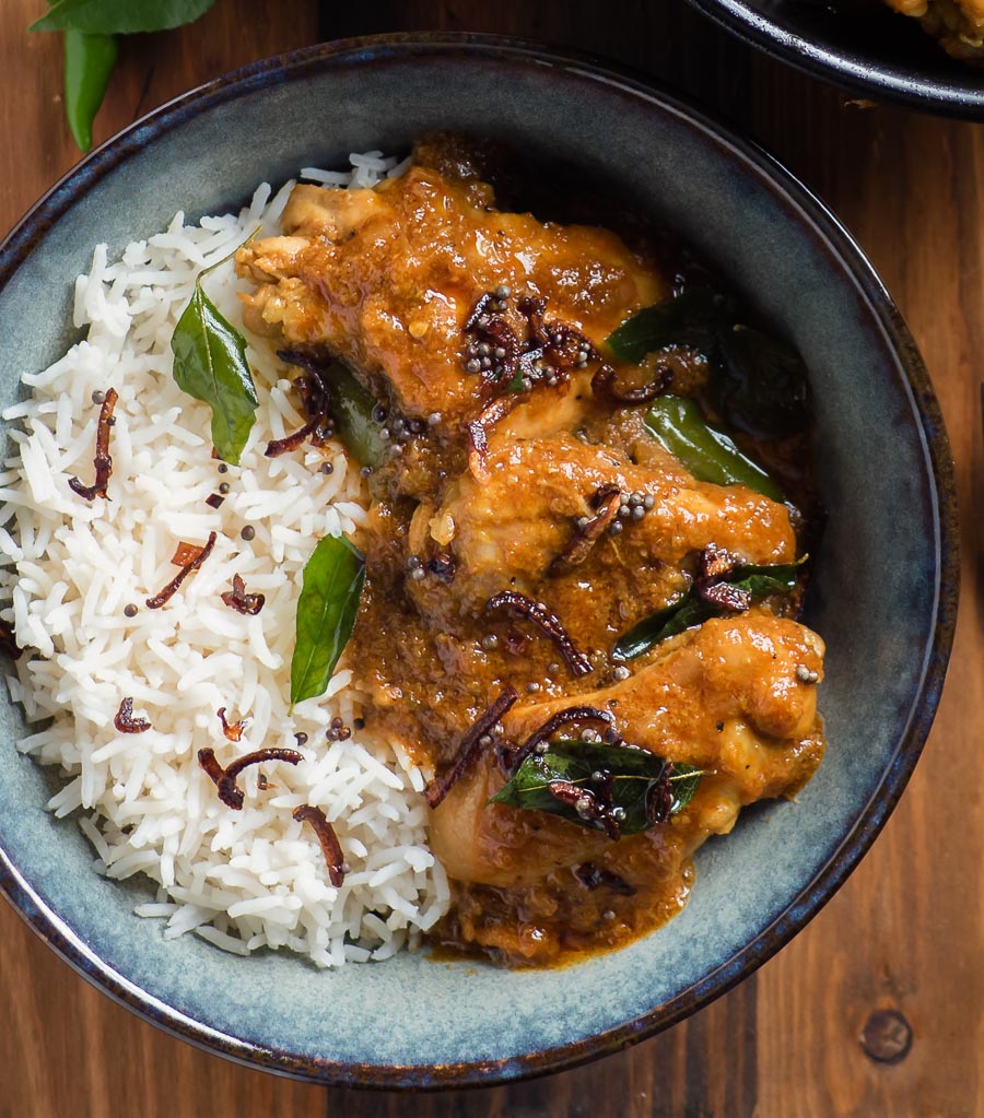 Nadan chicken curry and rice in a bowl from above.