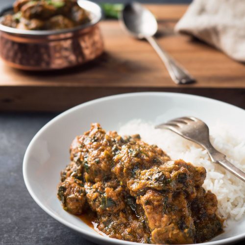 Lamb saag with rice on a plate.