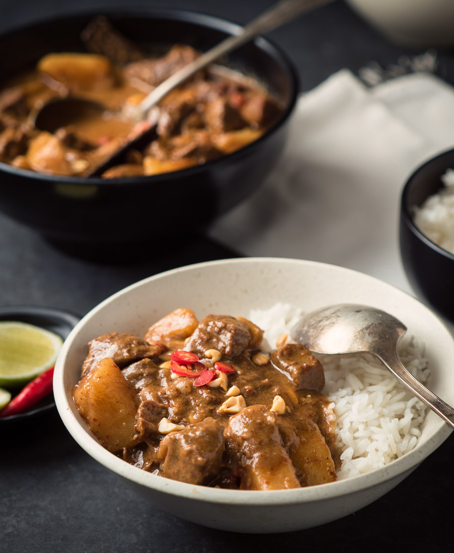 Beef massaman curry with rice and spoon.