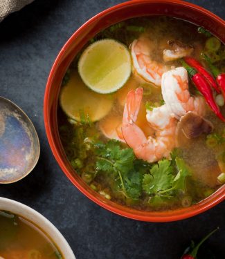 Tom yum soup in a big bowl from above.