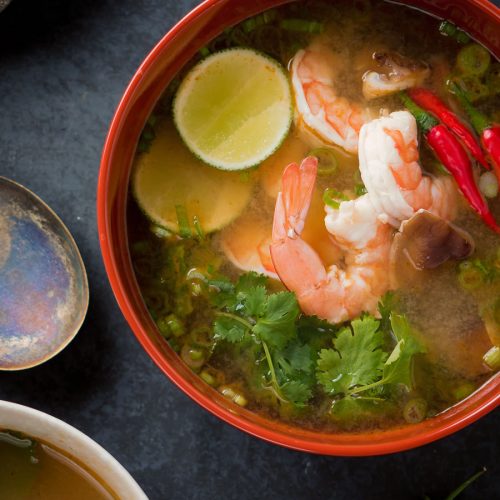 Tom yum soup in a big bowl from above.