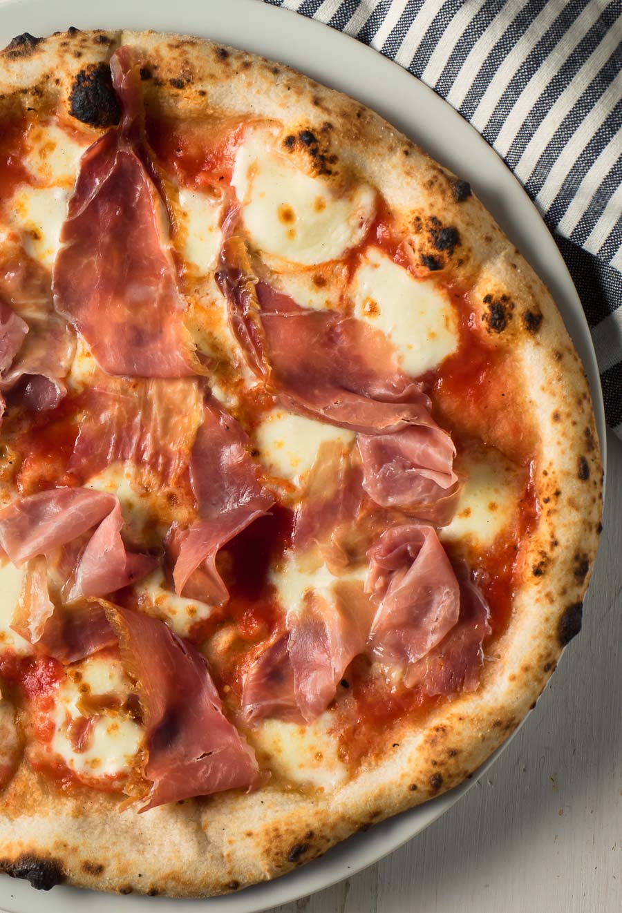 Neapolitan pizza with prosciutto and mozzarella