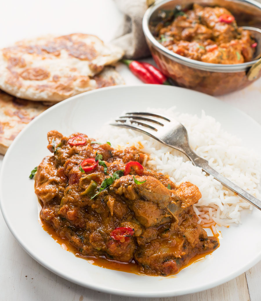 Restaurant karahi chicken curry served with rice.