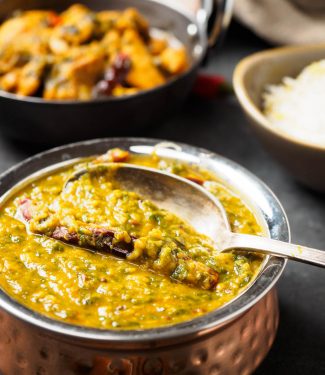 Dal palak close-up in a copper bowl.