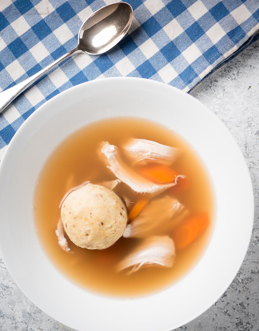 Matzo ball soup in a bowl from above.