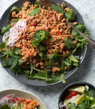 Thai larb salad with greens on a plate from above.