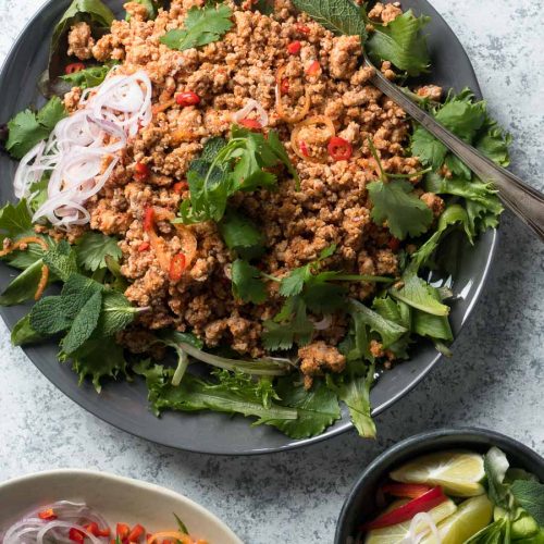 Thai larb salad with greens on a plate from above.