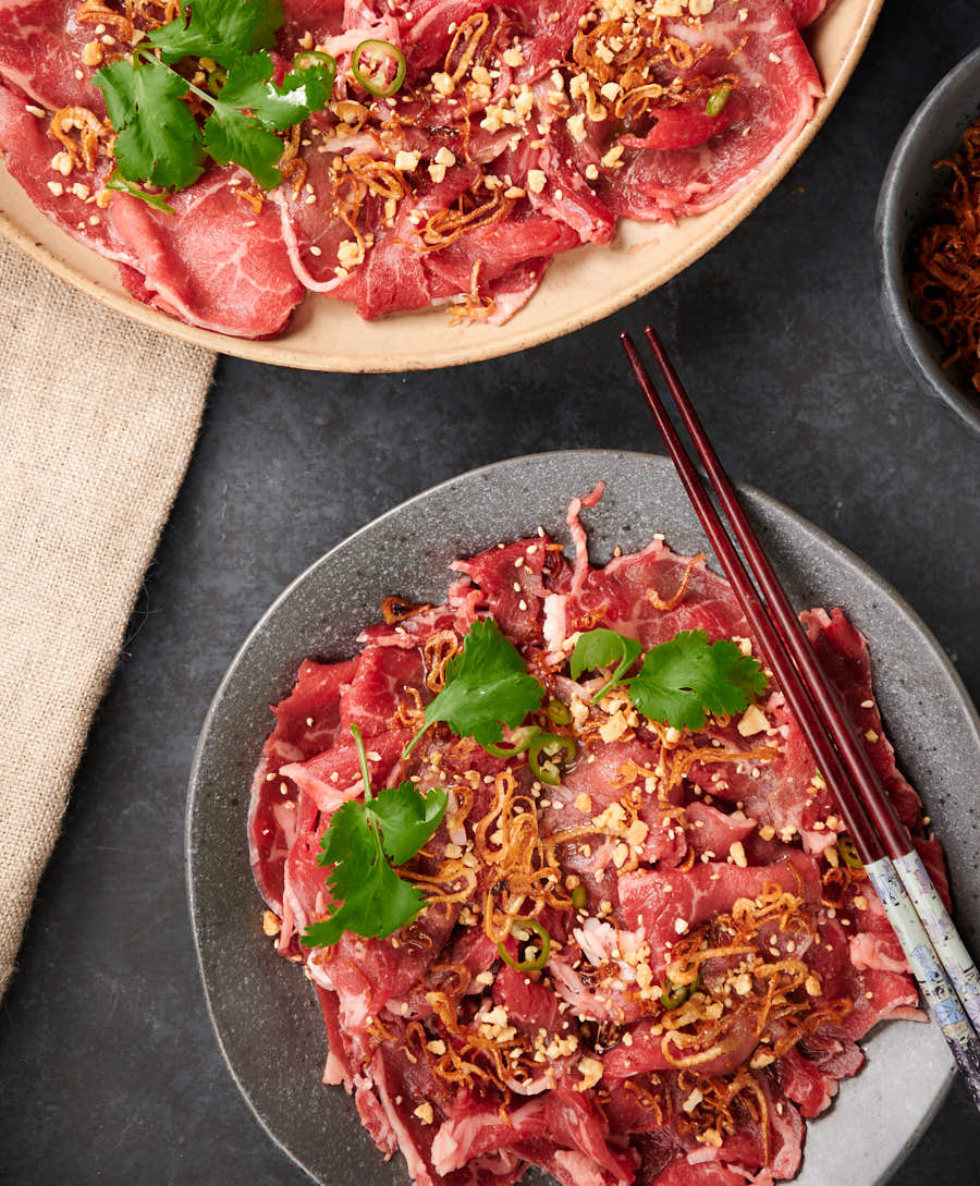 Asian style carpaccio on a plate with chopsticks. From above.