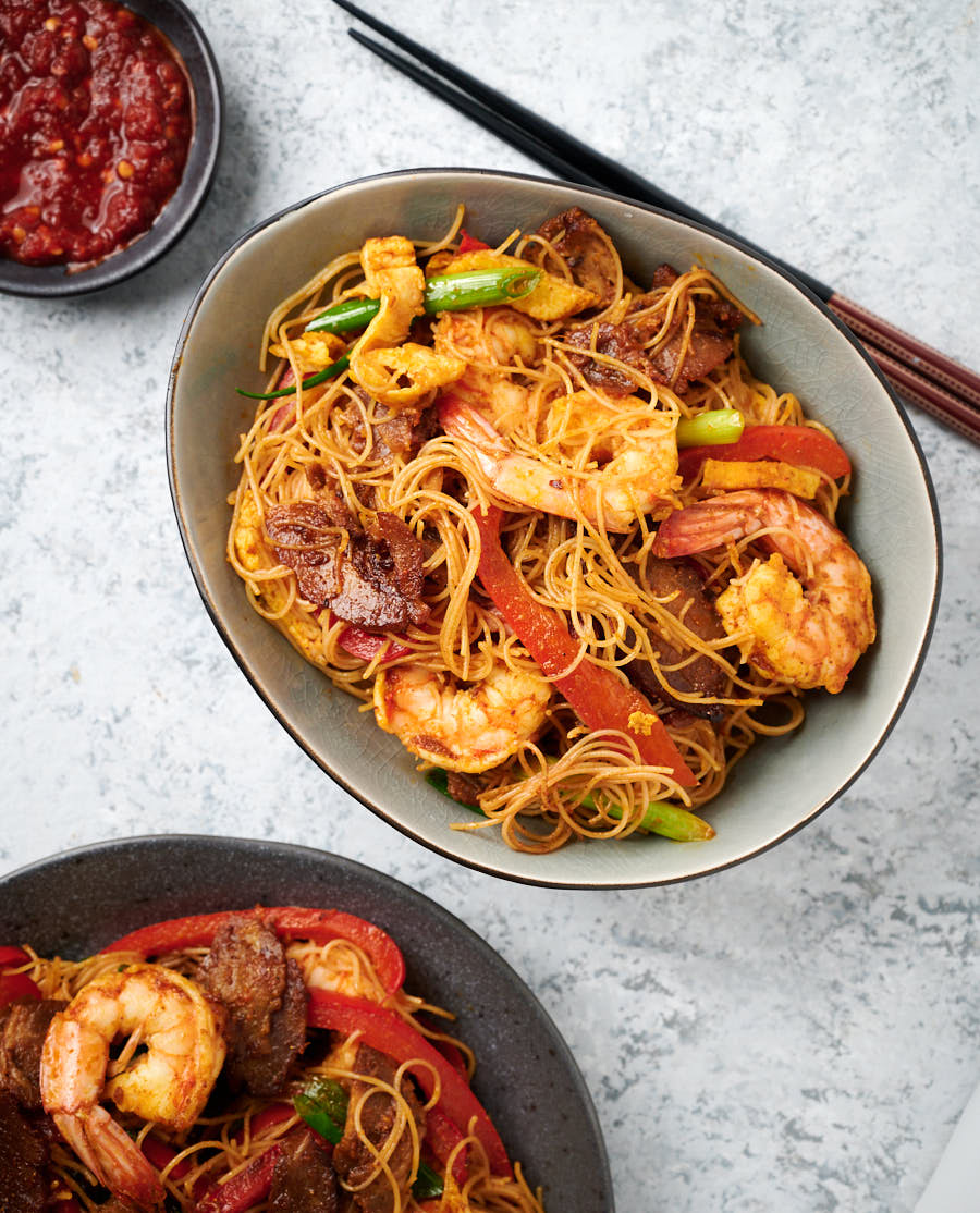 Singapore Noodles in a bowl from above. Chopsticks along side.