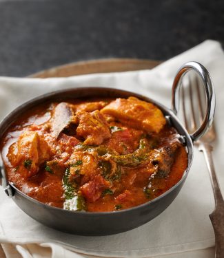 Chicken masala in a bowl from the front.