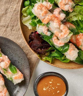 Overhead view of Vietnamese spring rolls on a platter and plate.