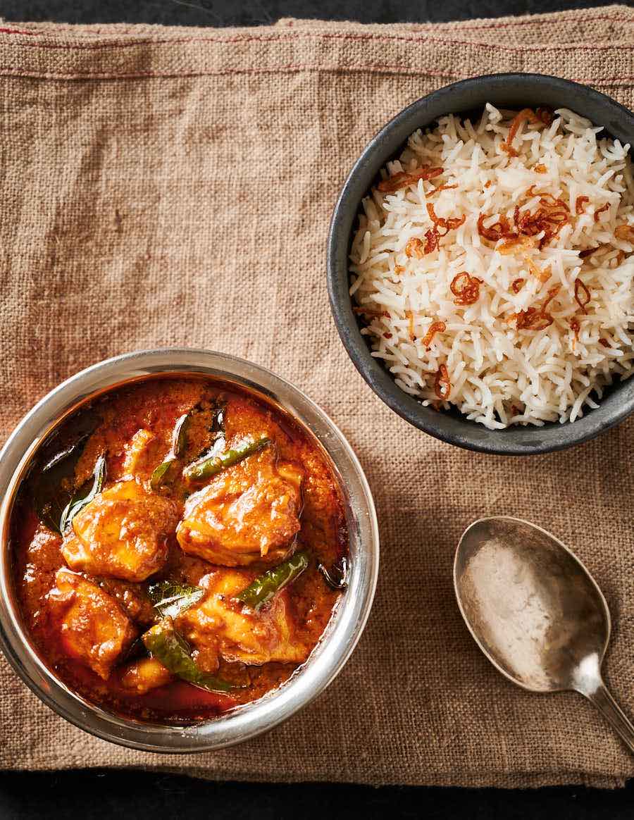 Masala chilli chicken and rice table scene from above.