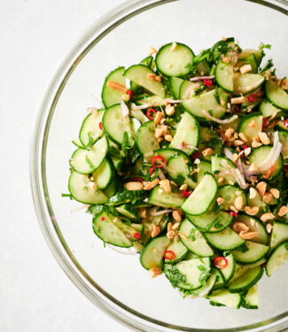 Thai cucumber salad in a large clear serving bowl from above.