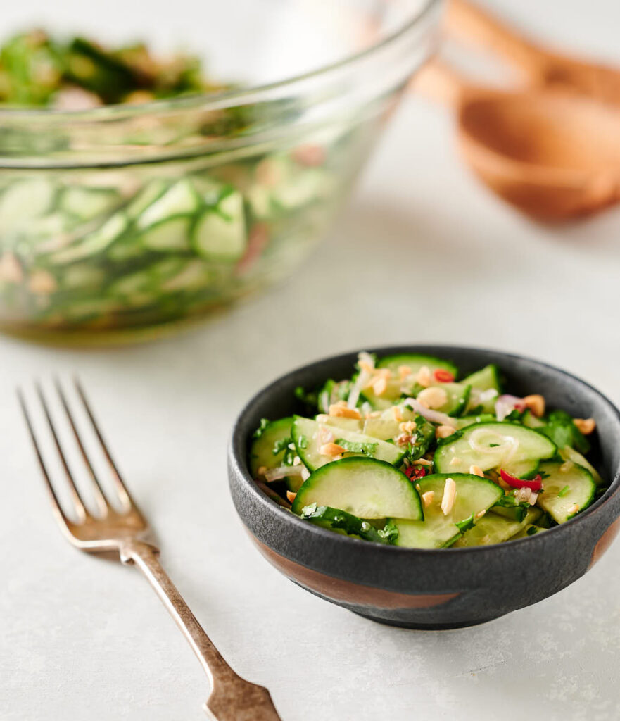 Thai cucumber salad in a small bowl table scene from the front.