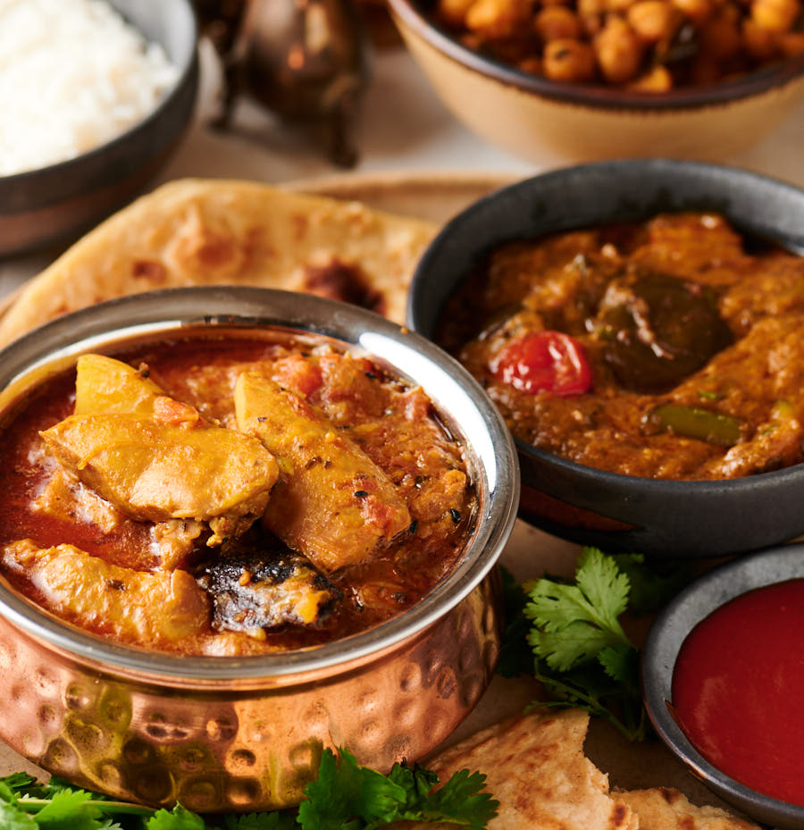 Murgir jhol, eggplant curry, rice and chickpea thali from the front.