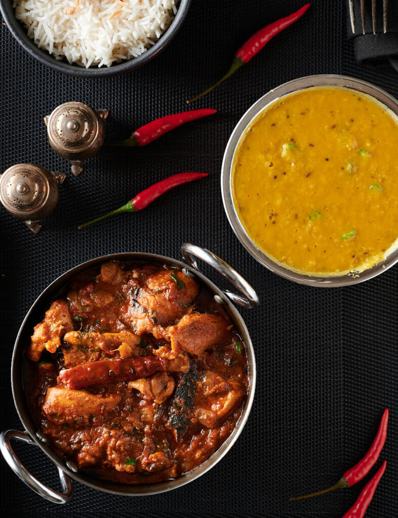 Bowls of chicken bhuna, dhal and rice from above.