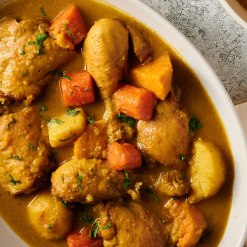 Closeup of Vietnamese chicken curry in an oval serving dish from above.