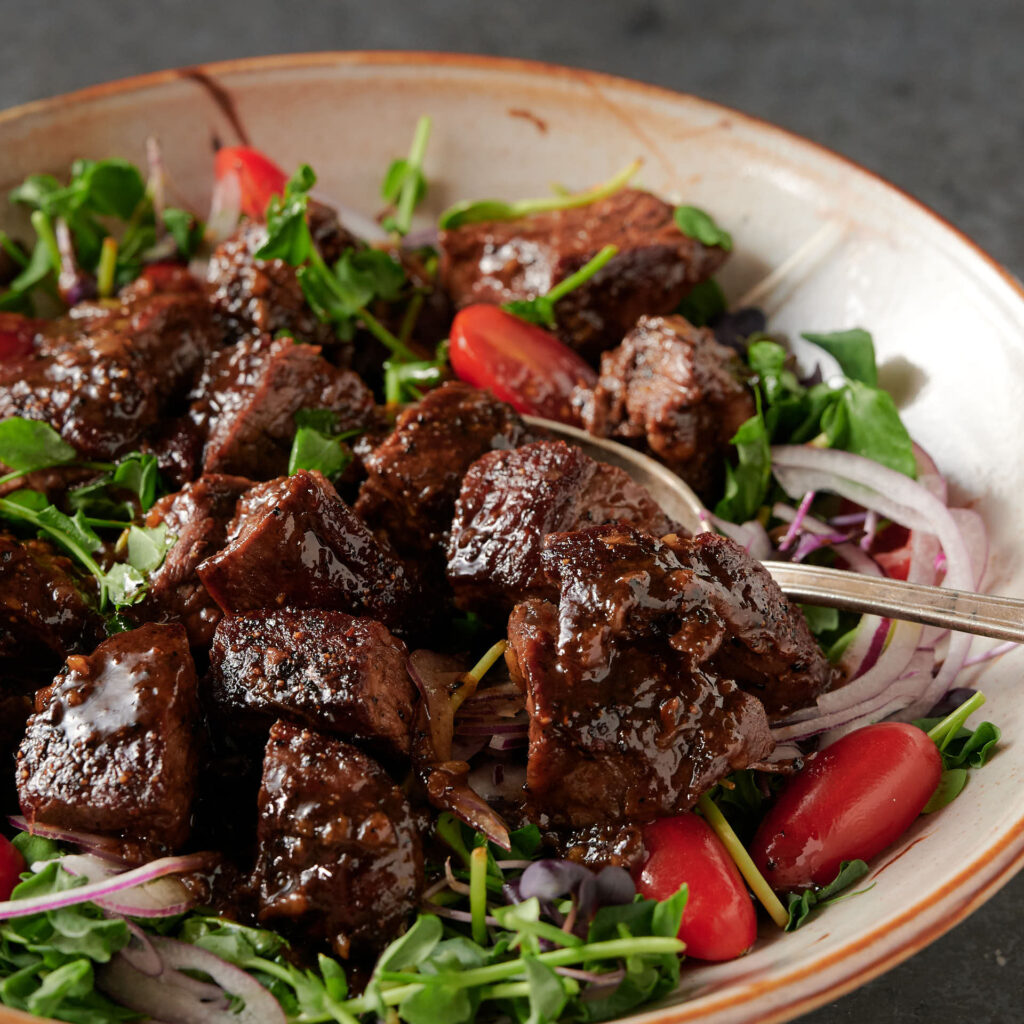 Spoon full of shaking beef - close up.